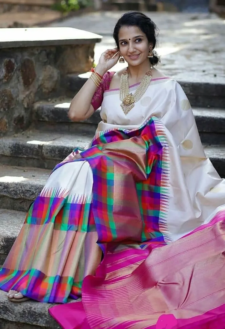 Woman wearing a white and multicoloured checked Kanchipuram silk saree